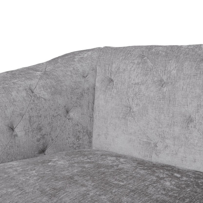 Canapé capitonné en velours gris clair avec accoudoirs évasés et assise profonde