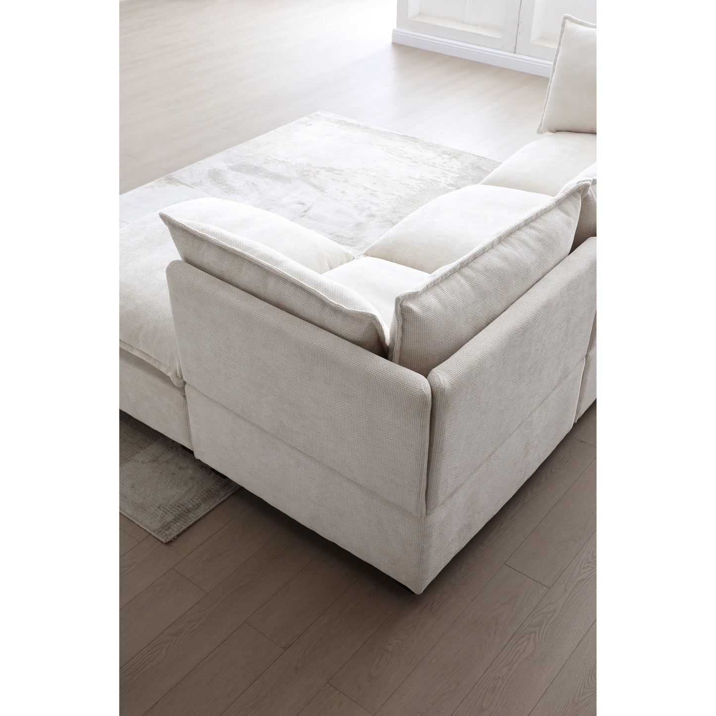 Canapé modulable en L en lin avec pouf réversible et coussins en duvet de canard moelleux, idéal pour le salon ou le bureau.